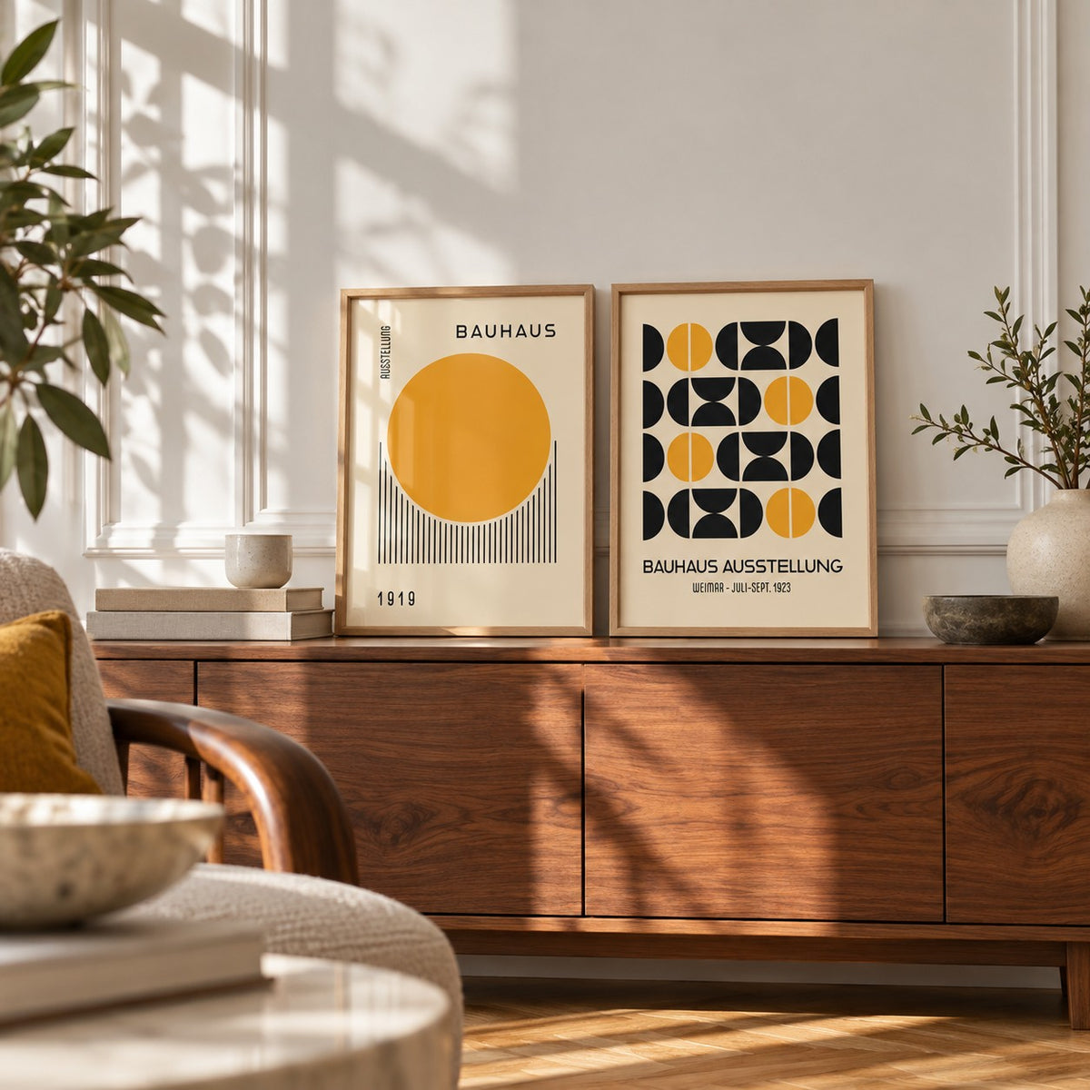 Yellow and Black Bauhaus Prints Set of 2 styled as small A4 prints on a shelf, to show the gift size: Golden Dawn and Bauhaus Symmetry shown framed side by side (frames not included)