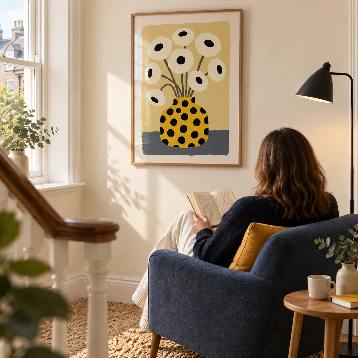 Yellow Vase Poster, framed on the wall of a bright reading corner on a wide landing in a UK townhouse with a warm cream wall in a living room