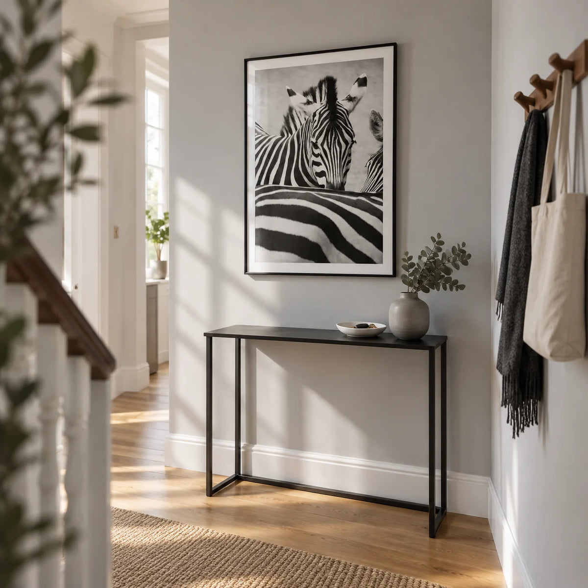 Zebra Black White Wall Art, framed on the wall of a bright narrow hallway in a renovated UK terrace with a pale grey wall and oak floor