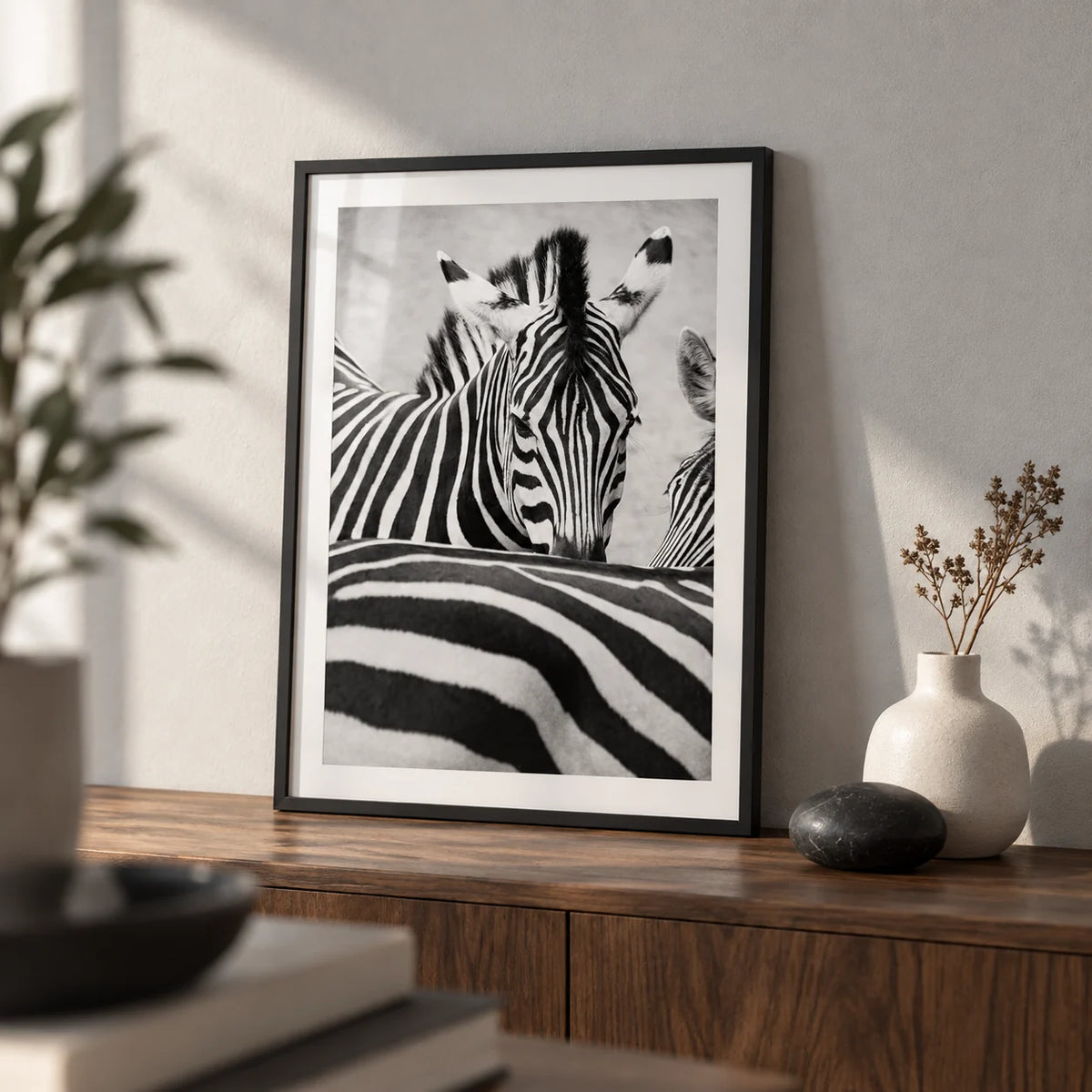 Zebra Black White Wall Art, a small A4 framed print leaning on a walnut shelf in a living room