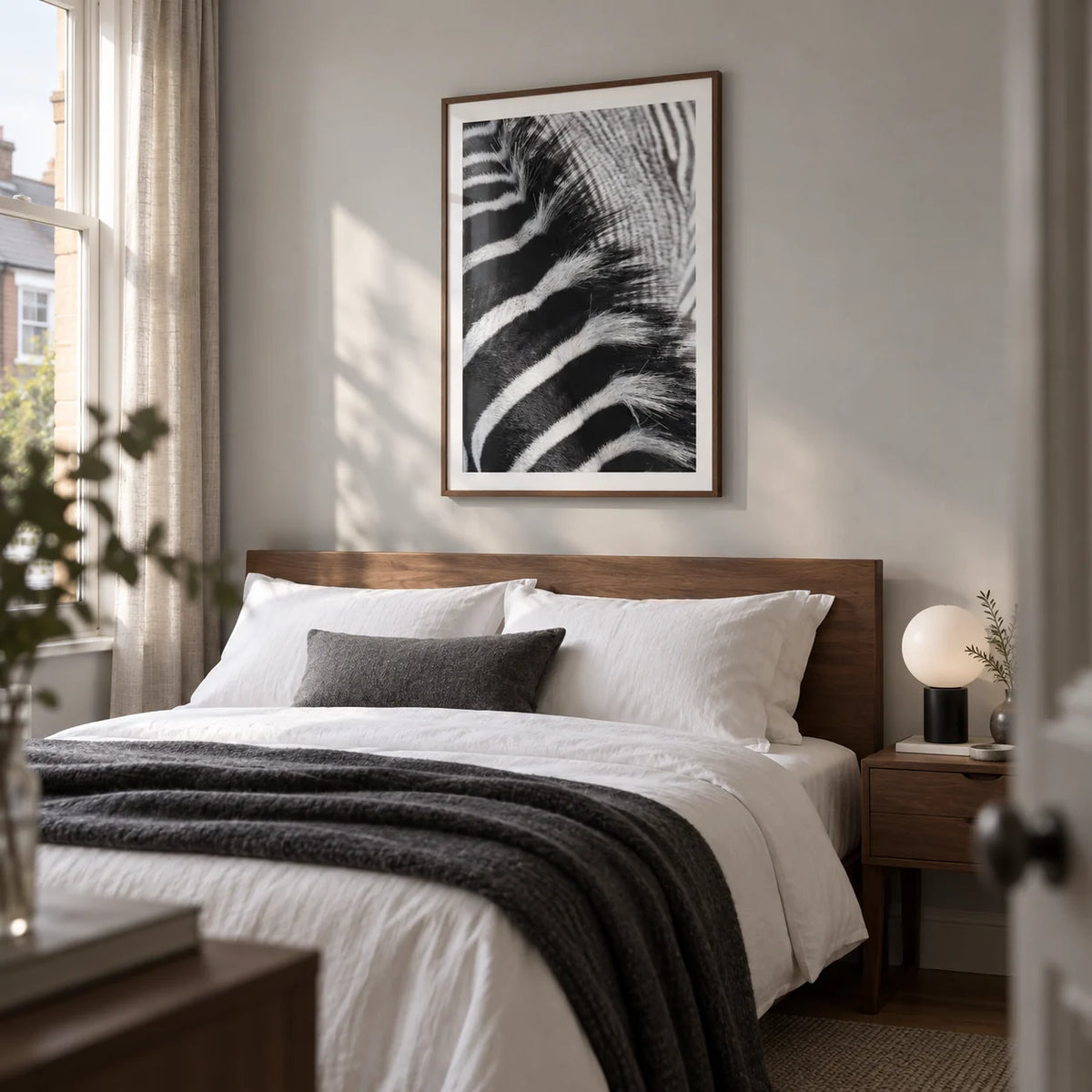 Zebra Stripe Art Print, framed on the wall of a calm contemporary bedroom in a UK terraced house with a pale grey wall