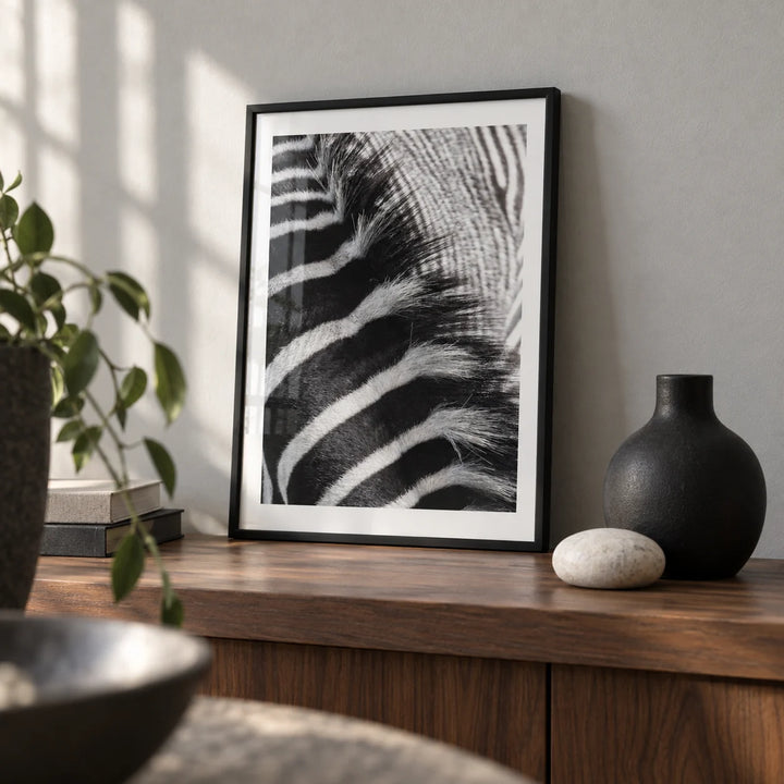 Zebra Stripe Art Print, a small A4 framed print leaning on a walnut shelf in a living room