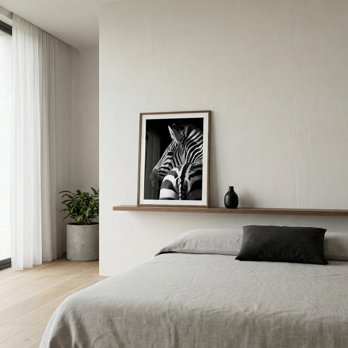 Modern bedroom with a zebra print framed picture on the wall above a bed.