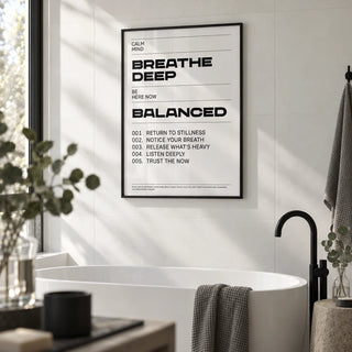Zen Quotes Breath, framed on the wall of a calm bathroom with large plain white tiles and a black tap