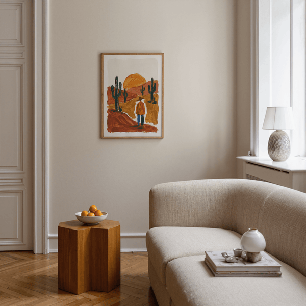 Impression artistique représentant un paysage désertique avec des cactus et des nuances orange, vertes et brunes pour la décoration d'une chambre à coucher.